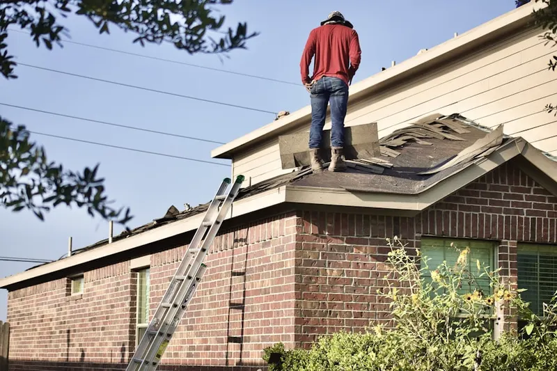 Professional roofer working on a residential roof in Malverne Park Oaks